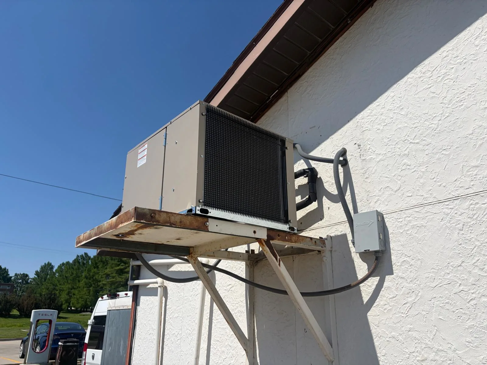 Commercial walk-in cooler outdoor condensing unit on wall bracket